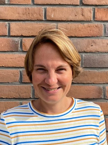 Camilla Chlebna against a brick wall