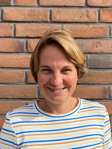 Camilla Chlebna against a brick wall